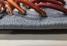 Load image into Gallery viewer, textile relief sculpture detail 3, vibrant playful colors on a muted blue background