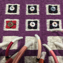 Load image into Gallery viewer, woven textile relief sculpture detail 3, playful colors on a dark wine background