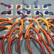 Load image into Gallery viewer, textile relief sculpture detail 1, vibrant playful colors on a muted blue background