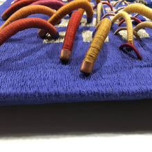 Load image into Gallery viewer, textile fiber relief sculpture detail 3, vibrant playful colors on a blue background