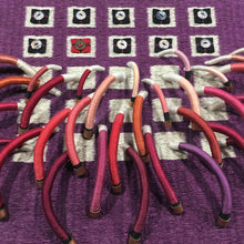 Load image into Gallery viewer, woven textile relief sculpture detail 1, playful colors on a dark wine background
