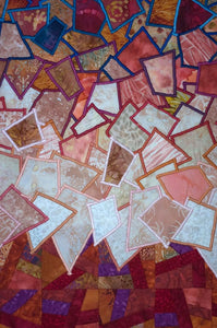 Unique machine quilted and appliquéd art quilt, detail 2, incorporating multi colored range with the overall color being red. 